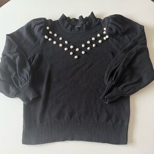 Black cotton sweater with cream pompoms